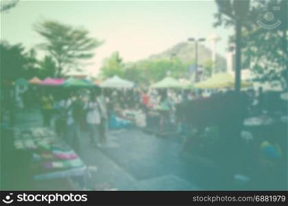 blur of people and tourists walk the streets at market phuket.