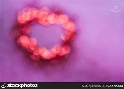 Blur of red bokeh with heart shape inside on pink background,valentine concept