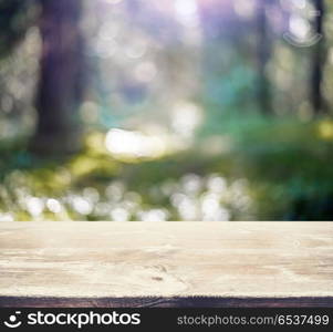 Blur summer forest bokeh. Blur summer forest bokeh. Wood plate background. Blur summer forest bokeh