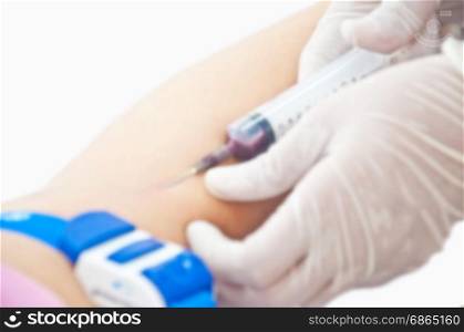 blurr of nurse use syringe for test blood and examination on white background