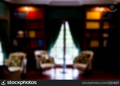 Blurred abstract background of book shelves row and interior of library with textbooks.