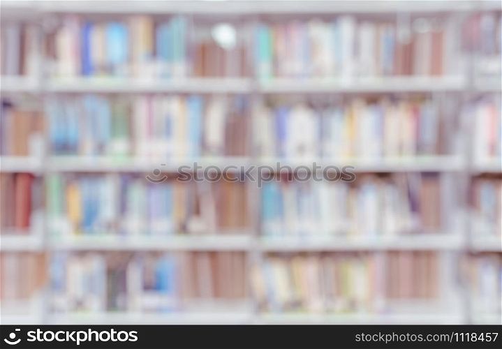 Blurred abstract background of bookshelves and interior of college or university library with textbooks and literature