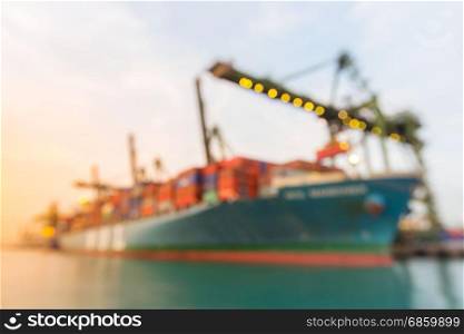 Blurred abstract background of Industrial port with container ship at dusk