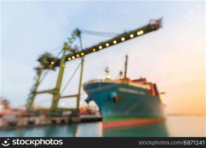 Blurred abstract background of Industrial port with container ship at dusk