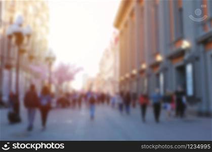 Blurred abstract background of people walking in street in the city, travel concept
