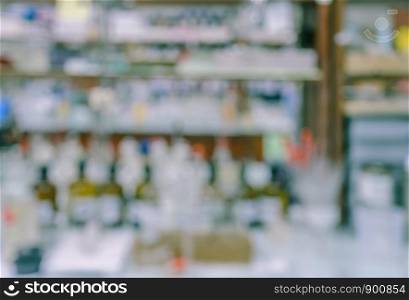Blurred abstract background of untidy workbench in chemistry laboratory