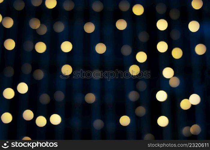 Blurred abstract hanging decorative lights with bokeh in night background