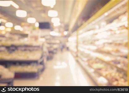 blurred abstract interior of people shopping in supermarket and miscellaneous product on shelves with vintage filter effect
