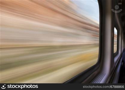 blurred abstract of canyon landscape seen from a train window in motion - travel concept