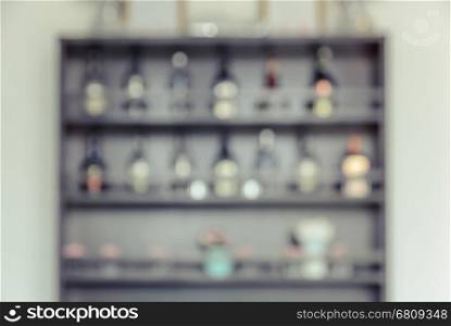 Blurred background image of bar back with shelf of liquor glass bottles