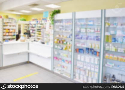 Blurred background. Interior of a pharmacy with goods and showcases. Medicines and vitamins for health. Shop concept, medicine and healthy lifestyle