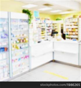 Blurred background. Interior of a pharmacy with goods and showcases. Medicines and vitamins for health. Shop concept, medicine and healthy lifestyle