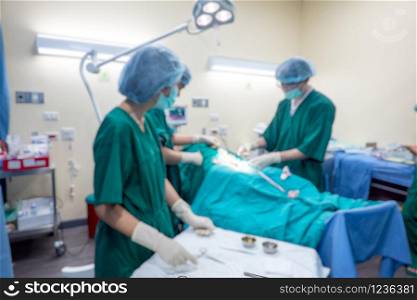 Blurred background of modern operating room at hospital with Group of surgeons in operating room with surgery equipment. Modern medical background