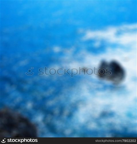 Blurred background of rocks in the sea with foam, square image