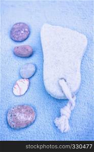 Blurred background of spa accessories - pebble, towel, pumice stone for feet.. Blurred background of spa
