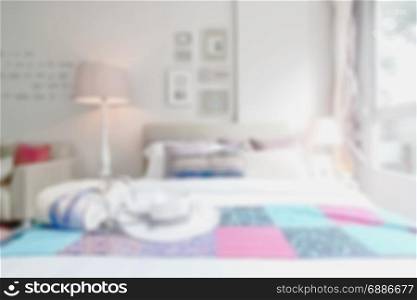 Blurred bedroom with bed and colorful decoration