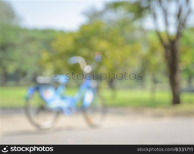 Blurred blue bicycle background in green park
