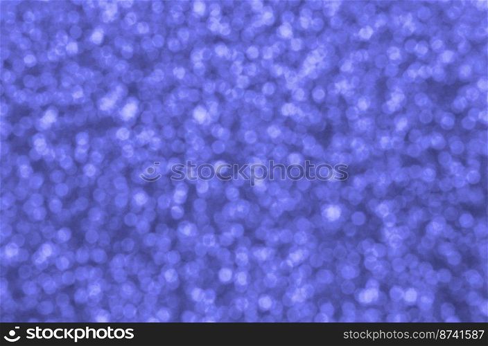Blurred blue decorative sequins. Background image with shiny bokeh lights from small elements that reflect light. Blurred blue decorative sequins. Background image with shiny bokeh lights from small elements