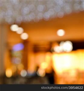 Blurred bokeh background. Beautiful background from blurred lights of interior. Color toned