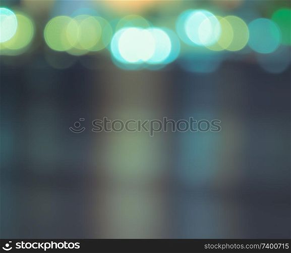 Blurred bokeh city lights with reflection on water