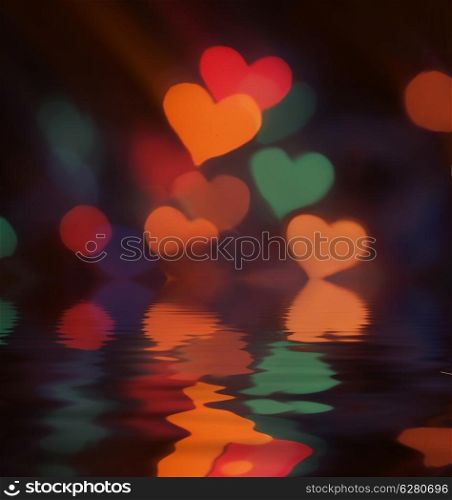 Blurred bokeh colorful lights with reflection in water.