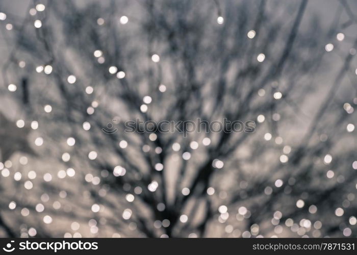 Blurred bokeh lights with deciduous tree on background, retro and vintage style image