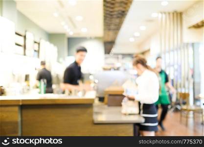 Blurred cafe background, Blur barista service customers at counter in coffee cafe background, food and drink business concept
