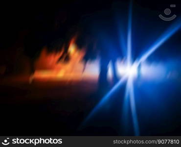 Blurred car driving fast in modern city night background. Defocused shot of car wheel drifting on night of city.. Defocused night drive in motion. Abstract blurry night drive.