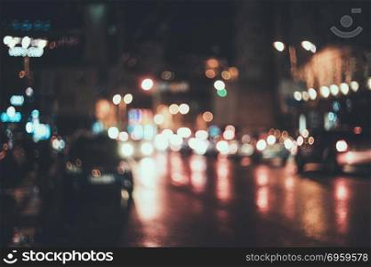 Blurred city at night. Bokeh. Beautiful abstract background with defocused buildings, cars, city lights, people. Colorful bokeh background with urban night scene. For design. Concept backdrop. Vintage. Blurred city at night. Bokeh. Blurred city at night. Bokeh