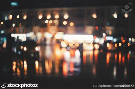 Blurred city at night. Bokeh. Beautiful abstract background with defocused buildings, cars, city lights, people. Colorful bokeh background with urban night scene. For design. Concept backdrop. Vintage. Blurred city at night. Bokeh. Abstract background. Blurred city at night. Bokeh. Abstract background