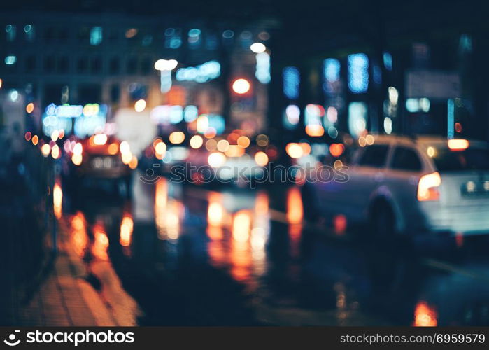 Blurred city at night. Bokeh. Blurred city at night. Bokeh. Beautiful abstract background with defocused buildings, cars, city lights, people. Colorful bokeh background with urban night scene. Design. Concept backdrop. Vintage. Blurred city at night. Bokeh