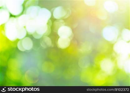 Blurred city park on background. Bokeh sun and blur green tree background.. Bokeh in morning forest and sun flares. Green leaf on blurred greenery background.