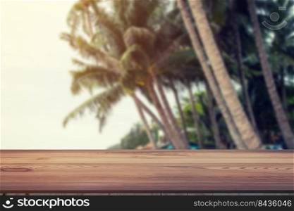 Blurred coconut on beach and wood table with space display for product.