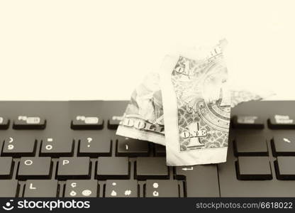 blurred crumpled dollar money background in a keyboard like concept of problem anc copy space
