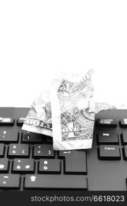 blurred crumpled dollar money background in a keyboard like concept of problem anc copy space
