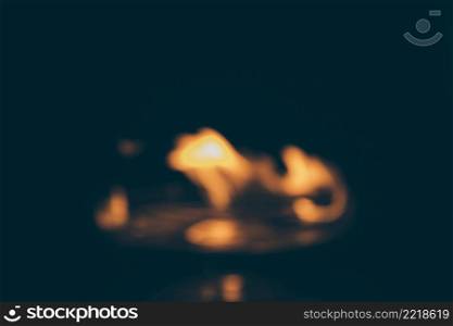 blurred dark background with burning flame