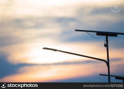 Blurred Electricity solar cells for street lighting, with dramatic sky background