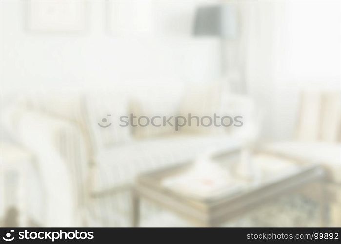 blurred elegant living room interior with striped pattern pillows on sofa - for background