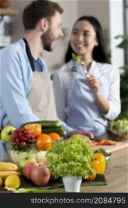 blurred focus couple feeding healthy salad standing kitchen counter