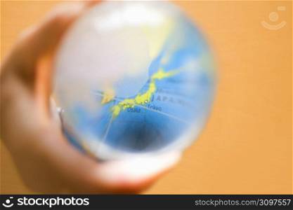 Blurred glass globe focusing on Japan