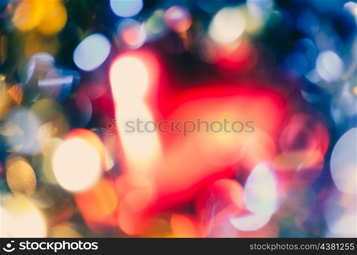 blurred holiday lights. Pretty bokeh as background with big spot of red color