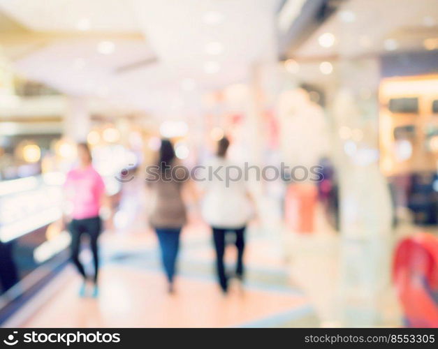 Blurred image background, people at shopping mall blur background with bokeh and vintage tone.