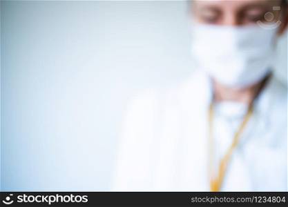 blurred image of a doctor wearing mask