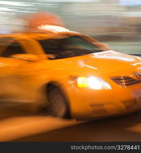 Blurred image of a yellow taxi in Manhattan, New York City, U.S.A.