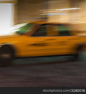 Blurred image of a yellow taxi in Manhattan, New York City, U.S.A.