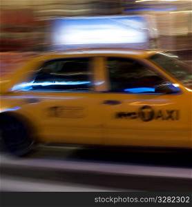 Blurred image of a yellow taxi in Manhattan, New York City, U.S.A.