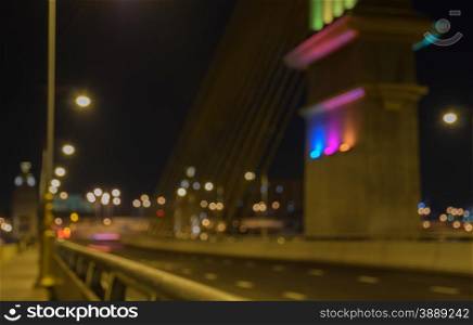 Blurred image of cable bridge at night with bokeh