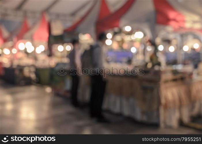 Blurred image of people shopping on street with bokeh, vintage color