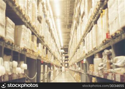Blurred image of shelf in modern distribution warehouse or store. Blurred image of shelf in modern distribution warehouse or storehouse. Defocused background of industrial warehouse interior aisle. Blurred image of shelf in modern distribution warehouse or storehouse. Defocused background of industrial warehouse interior aisle