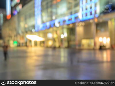 Blurred image of shopping mall with shining lights at night